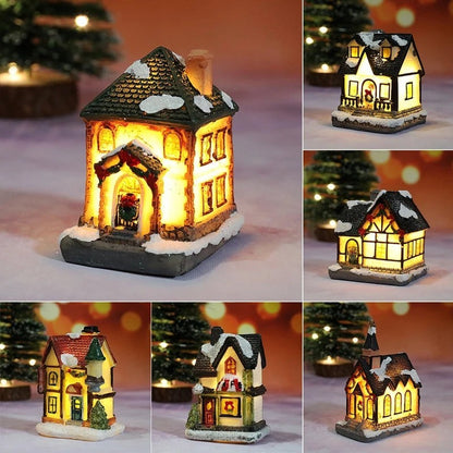 Collage of a small illuminated house ornament with snowy roof and lit interior, set against a blurred Christmas tree background.