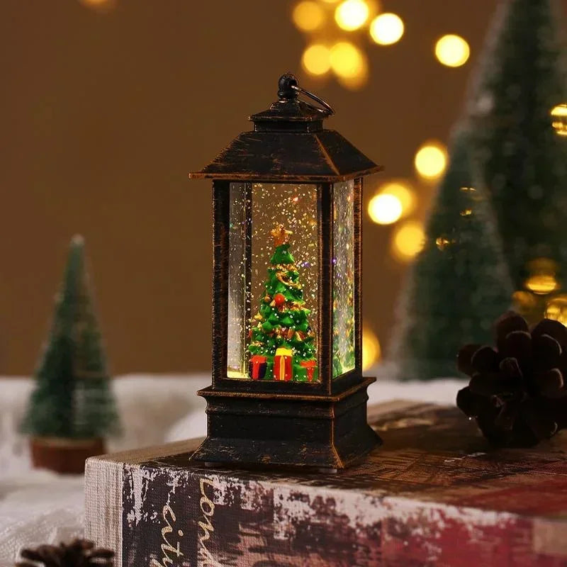 Decorative lantern with a Christmas scene inside, surrounded by festive decorations on a blurred background.