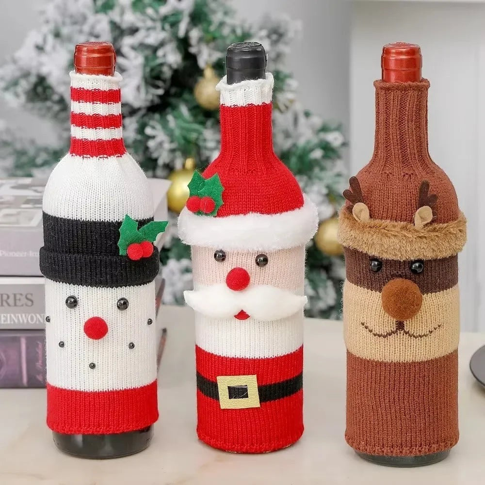 TK-H Merchandise set of three knitted Christmas wine bottle covers featuring Santa, snowman, and elk designs.